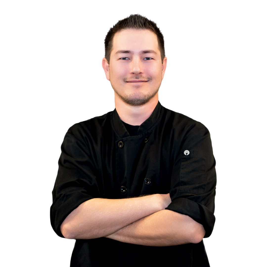 Chef Daniel of Makoto Catering standing with his arms crossed in a black chef coat